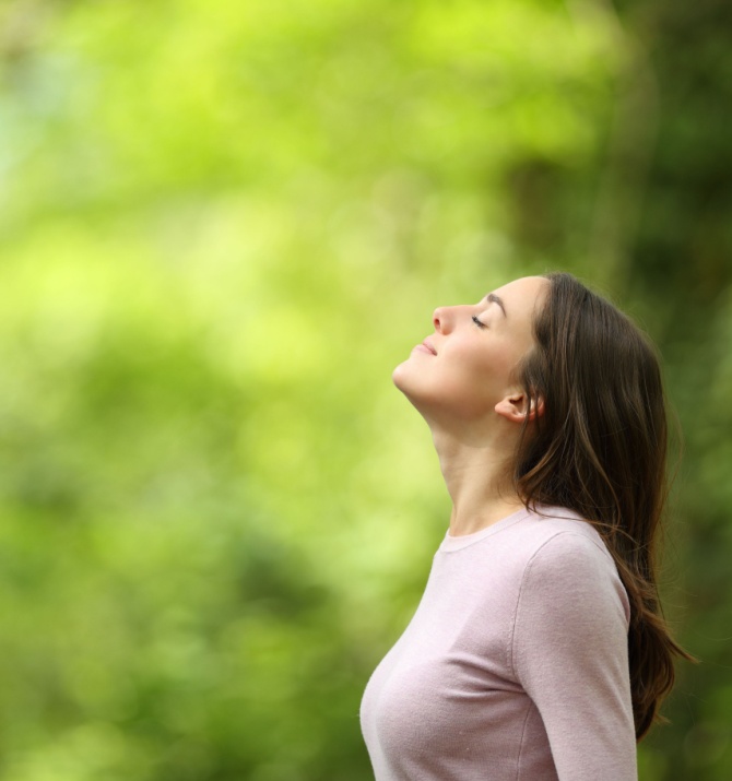woman looking up at the trees.