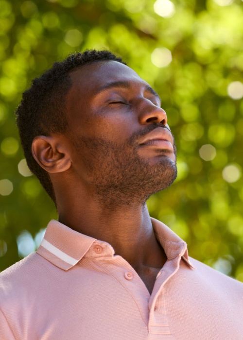 Man Outdoors Relaxing closing Eyes And Breathing