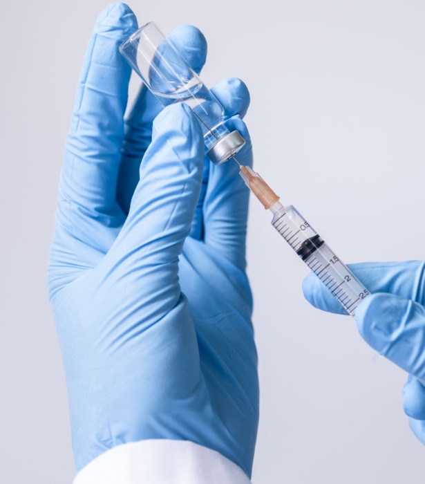 doctor pulling vitamin serum into needle