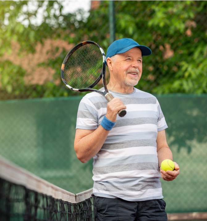 active senior man playing tennis in the outdoor