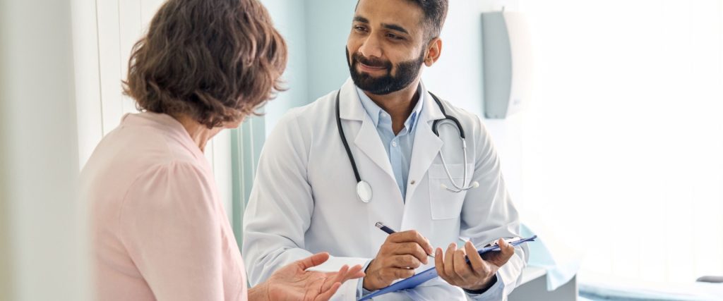 male doctor consulting senior old patient
