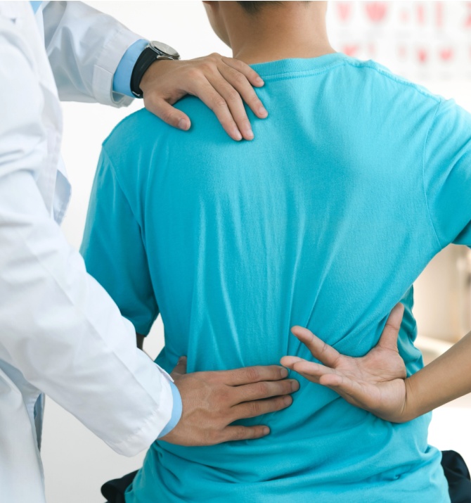 Doctor physiotherapists treat lower back pain on patients