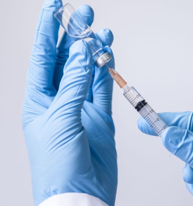 doctor pulling vitamin serum into needle