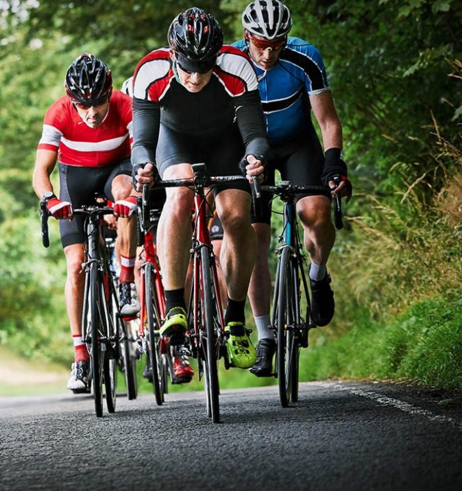 Cycling racing down road side